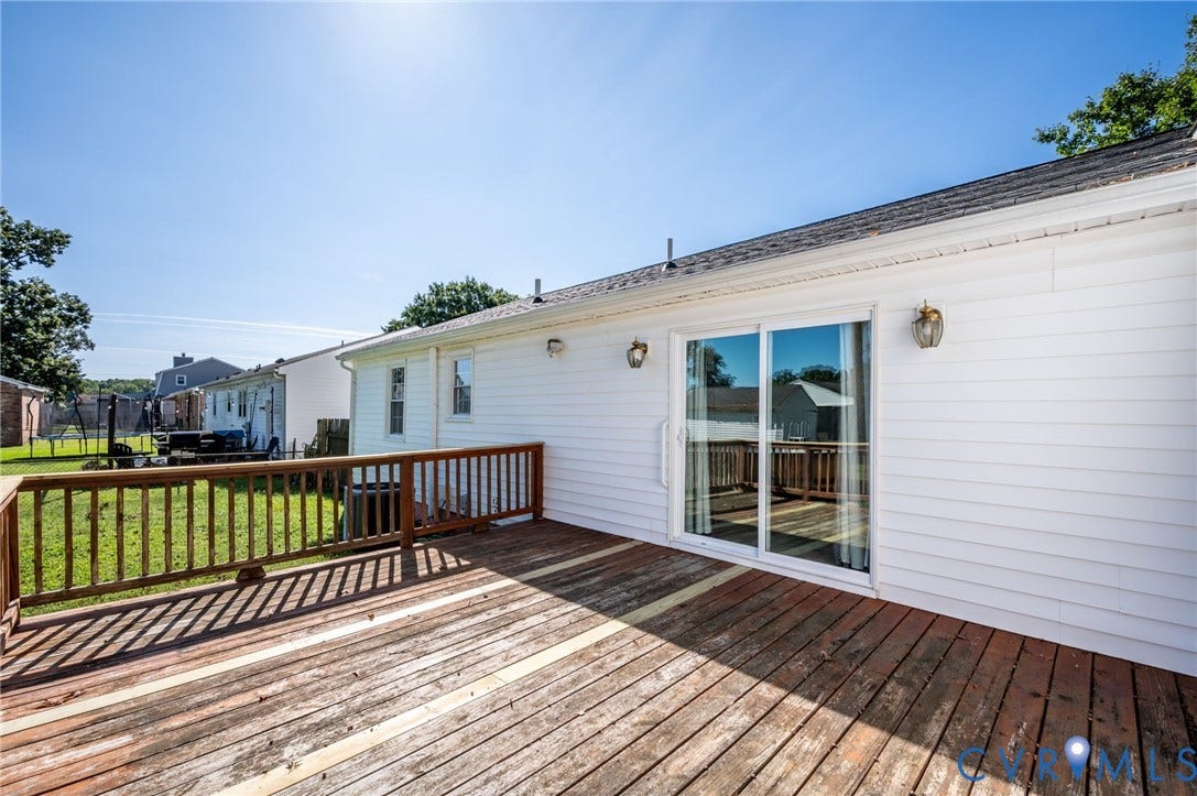912 Williamsburg Road, Colonial Manor, Colonial Heights, VA 23834 Expansive outdoor wood deck with wood railing, white siding, and sliding glass door access