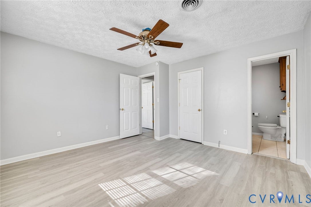 912 Williamsburg Road, Colonial Manor, Colonial Heights, VA 23834 Neutral wall paint, wood-finish flooring, ceiling fan with light fixture, paneled doors, and a private water closet