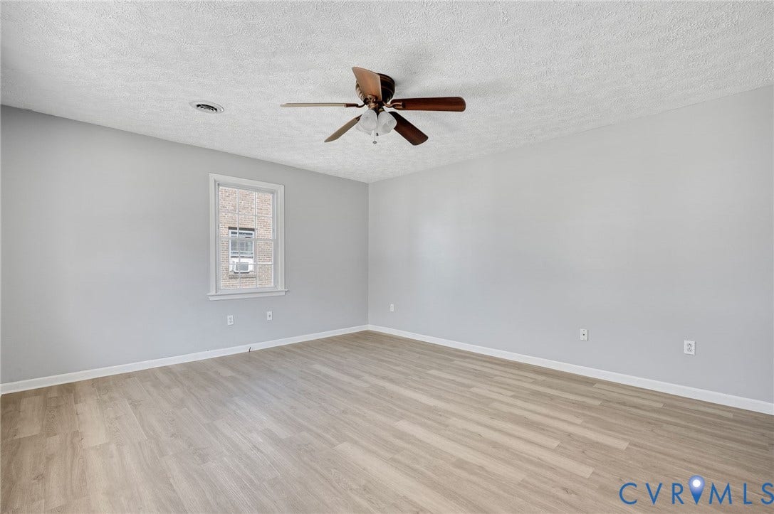 912 Williamsburg Road, Colonial Manor, Colonial Heights, VA 23834 Light-toned wood-finish flooring, neutral wall paint, and a ceiling fan with integrated lighting