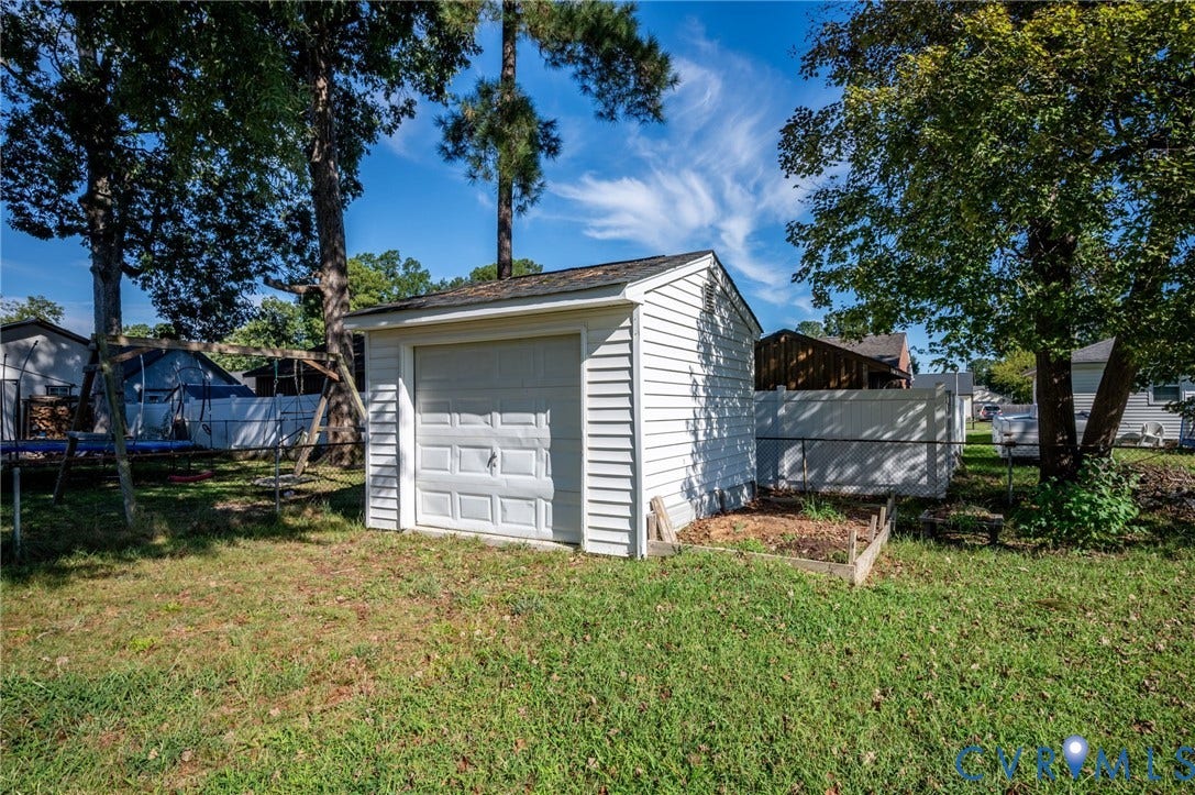 912 Williamsburg Road, Colonial Manor, Colonial Heights, VA 23834 Detached utility shed with a roll-up garage door