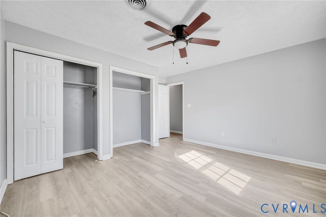 912 Williamsburg Road, Colonial Manor, Colonial Heights, VA 23834 Wood-finish flooring, ceiling fan with light fixture, light gray wall tones, and bi-fold closet doors