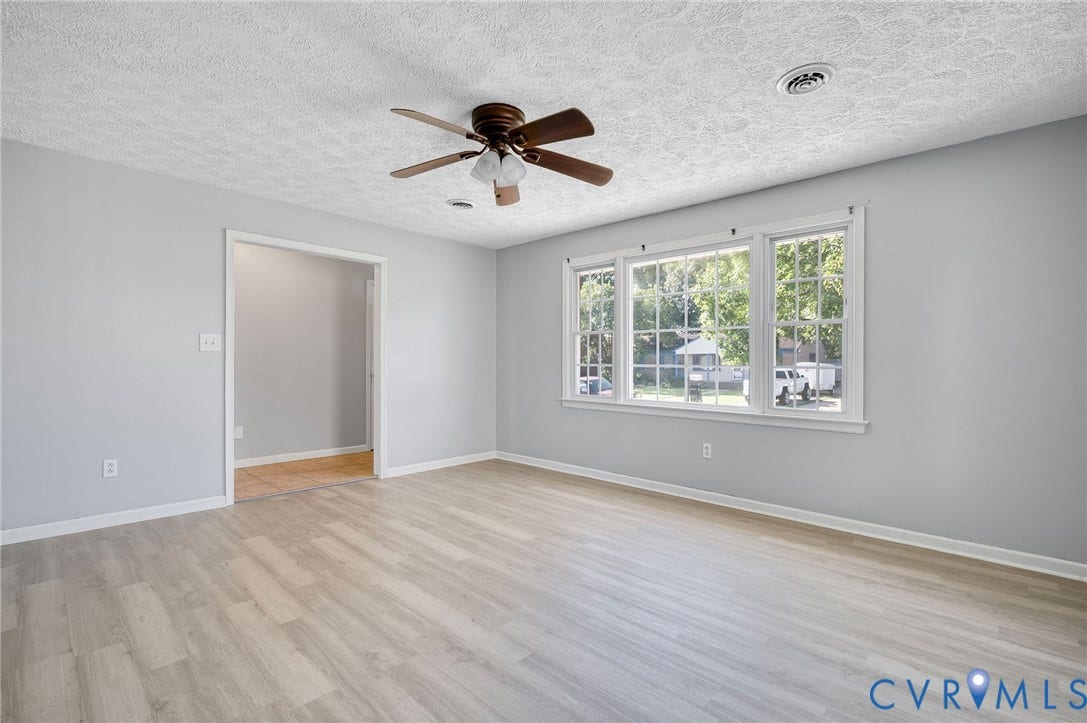 912 Williamsburg Road, Colonial Manor, Colonial Heights, VA 23834 Light wood-finish flooring, white trim, and a ceiling fan with integrated lighting