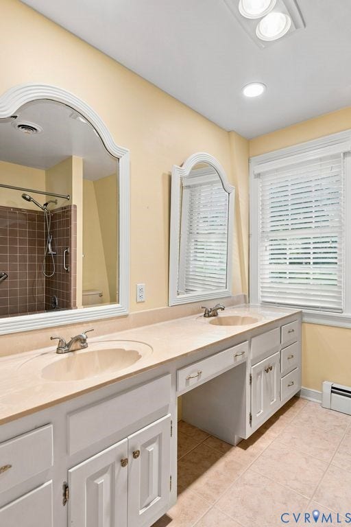 2425 Chancellor Road, North Chesterfield, VA 23235 2nd Floor Primary Bathroom. Dual vanity with integrated sinks, white cabinetry, and a light-toned countertop