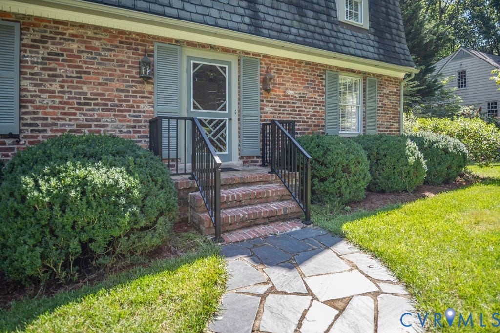 2425 Chancellor Road, North Chesterfield, VA 23235 Brick facade, dormer window, slate walkway, metal railings, manicured shrubs