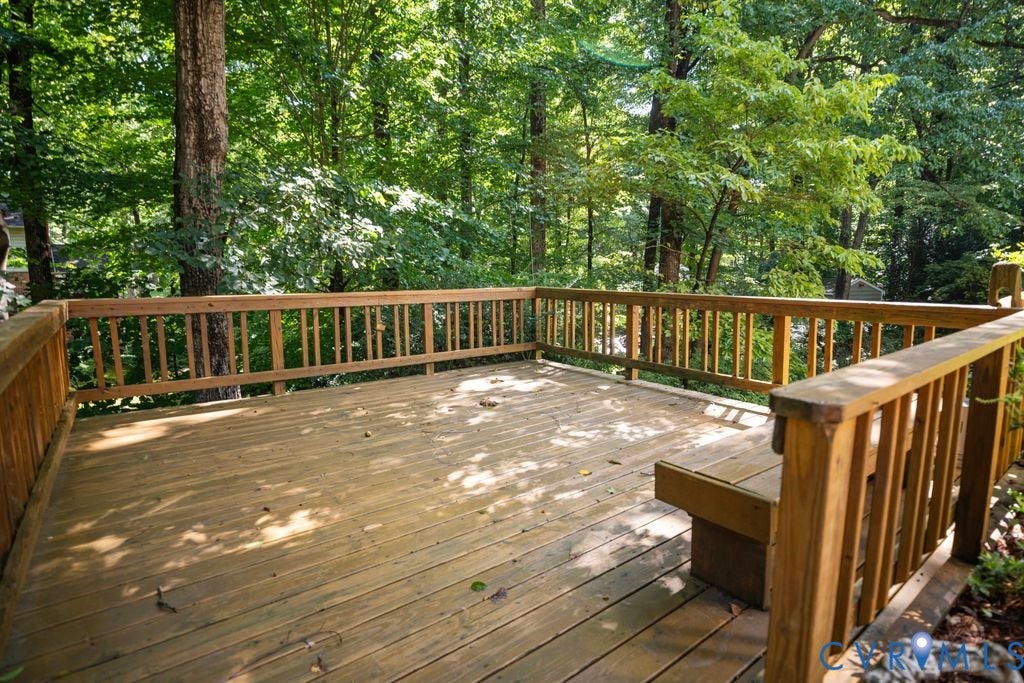 2425 Chancellor Road, North Chesterfield, VA 23235 Expansive wood deck with natural wood railing and integrated bench seating, surrounded by mature trees