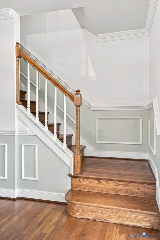 2425 Chancellor Road, North Chesterfield, VA 23235 Hardwood flooring, wood staircase with white risers, wood handrail, white balusters, and wainscoting with decorative trim
