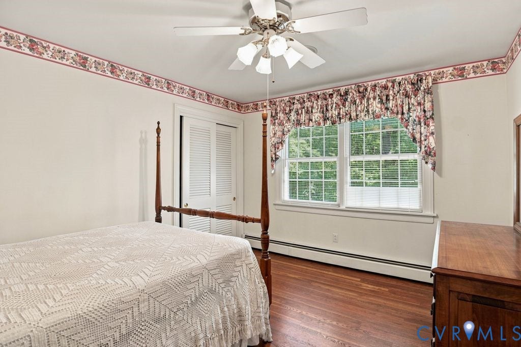 2425 Chancellor Road, North Chesterfield, VA 23235 2nd Floor Bedroom #3. Hardwood flooring, ceiling fan with integrated lighting, bi-fold louvered closet doors, and a double window