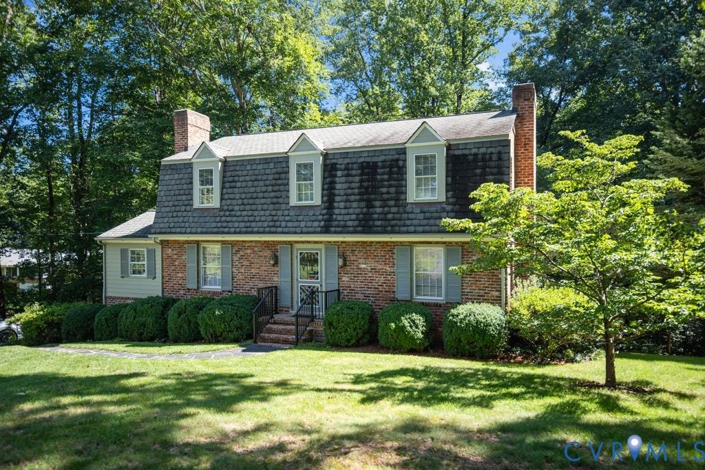2425 Chancellor Road, North Chesterfield, VA 23235 Brick exterior with dormer windows, a prominent chimney, and a landscaped front yard
