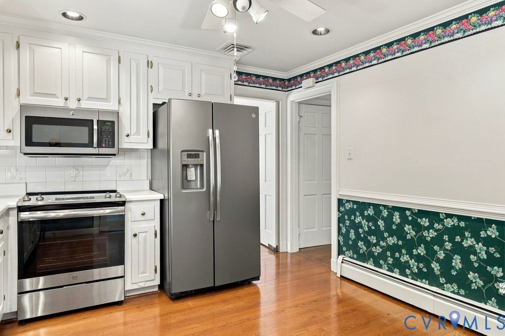 2425 Chancellor Road, North Chesterfield, VA 23235 White cabinetry, stainless steel appliances, white tile backsplash, light wood-finish flooring, and recessed lighting