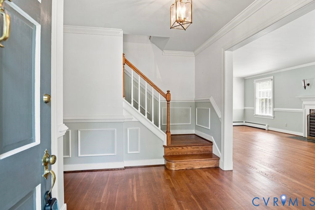 2425 Chancellor Road, North Chesterfield, VA 23235 Hardwood flooring, wainscoting, and a detailed staircase with wood railing