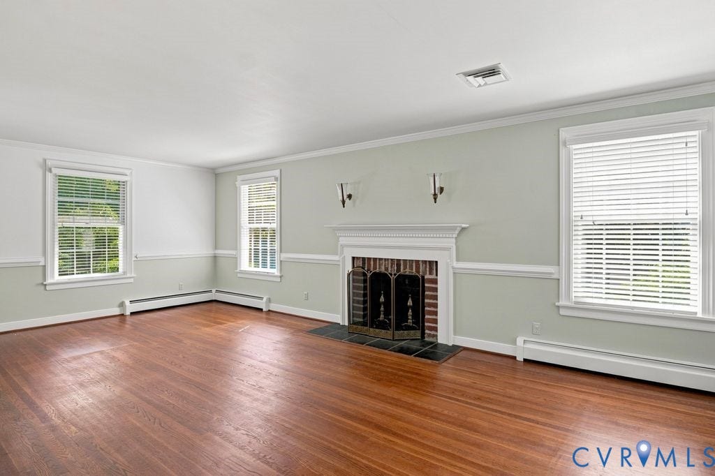 2425 Chancellor Road, North Chesterfield, VA 23235 Hardwood flooring, brick fireplace with decorative mantel, dual windows, and wall sconces