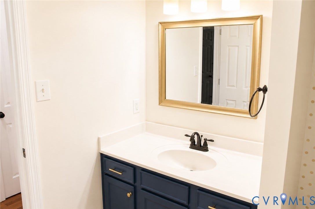 2120 Oakhampton Place, Henrico, VA 23233 Vanity with deep blue cabinetry, gold hardware, and a white countertop