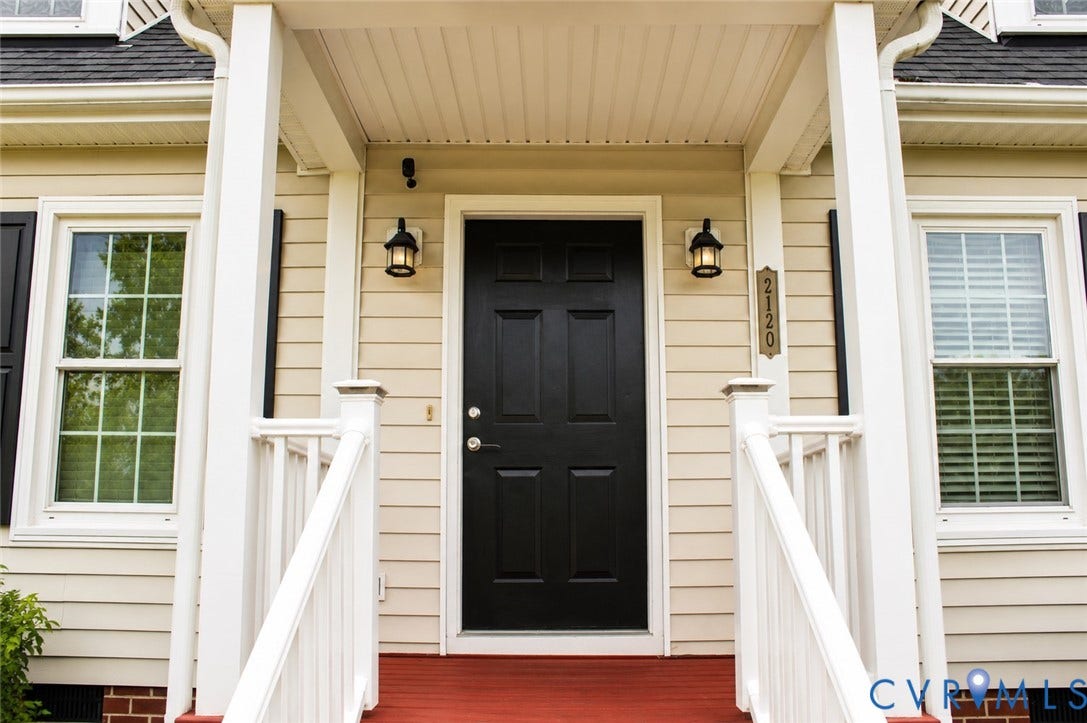 2120 Oakhampton Place, Henrico, VA 23233 Inviting front porch featuring a black paneled door with brass hardware, flanked by two outdoor wall lanterns
