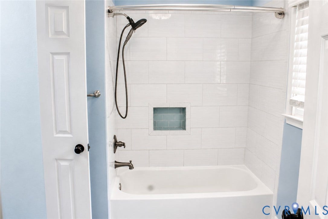2120 Oakhampton Place, Henrico, VA 23233 Bathtub and shower combination featuring white subway tile surround