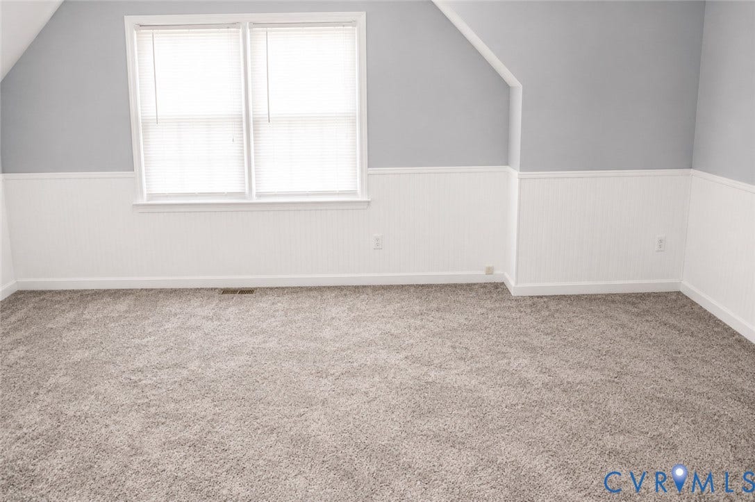 2120 Oakhampton Place, Henrico, VA 23233 Carpeted room featuring a double window, beadboard wainscoting, light gray walls, and an angled ceiling