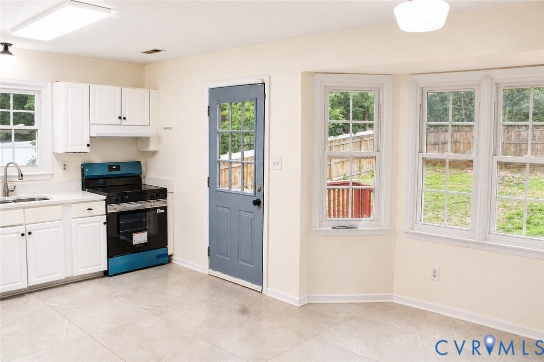 2120 Oakhampton Place, Henrico, VA 23233 Kitchen featuring white cabinetry, a stainless steel sink with a gooseneck faucet, a blue and black range, and light-toned tile flooring