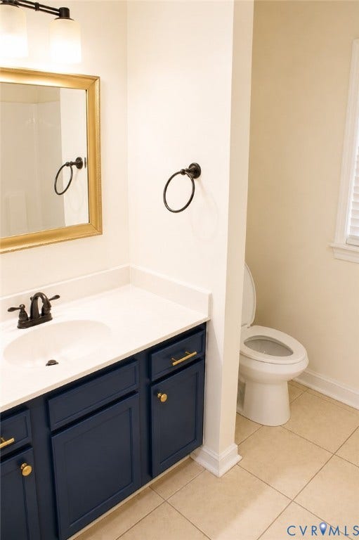 2120 Oakhampton Place, Henrico, VA 23233 Bathroom vanity featuring a white undermount sink, dark blue cabinetry with gold hardware, and a white countertop