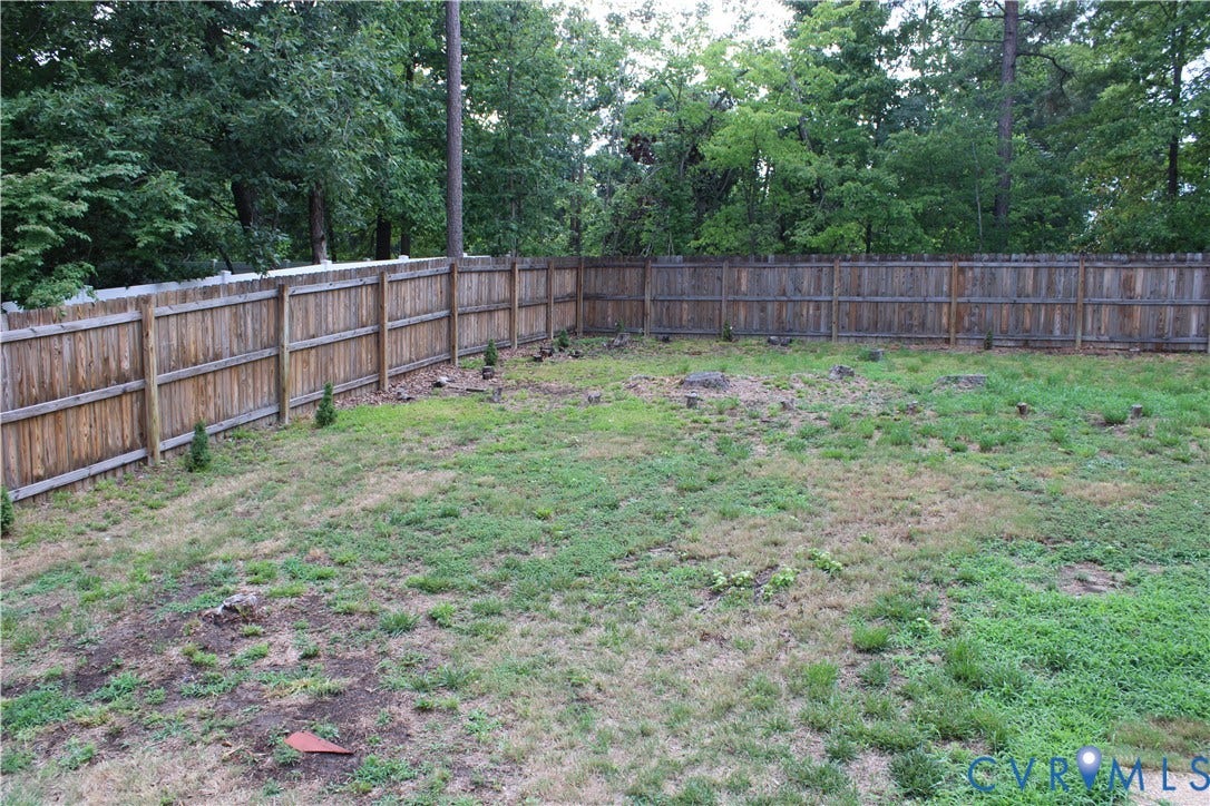 2120 Oakhampton Place, Henrico, VA 23233 Spacious backyard featuring a full perimeter privacy fence and established natural tree line