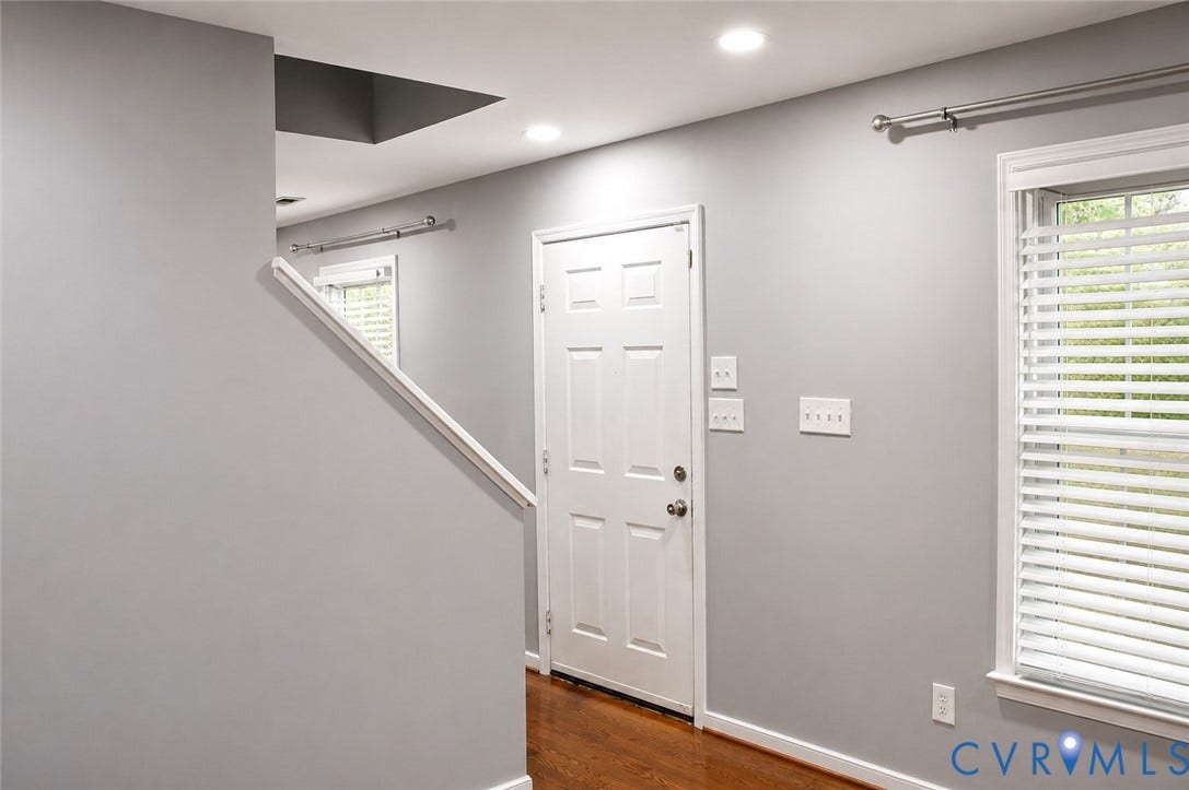 2120 Oakhampton Place, Henrico, VA 23233 Entryway featuring a white paneled door, wood-finish flooring, and light gray wall paint