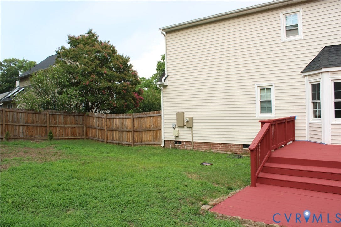2120 Oakhampton Place, Henrico, VA 23233 Expansive backyard featuring a stained wood privacy fence and a red painted deck with railings