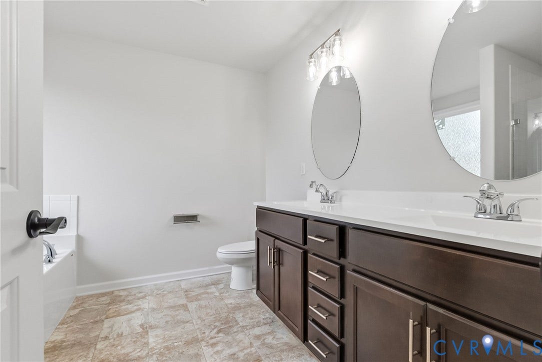 2007 Arcadia Avenue, Chester, VA 23831 Dual vanity with dark wood-finish cabinetry, chrome hardware, and white countertops