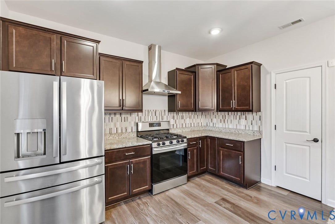 2007 Arcadia Avenue, Chester, VA 23831 Kitchen featuring wood-finish flooring, dark wood cabinetry, and stainless steel appliances