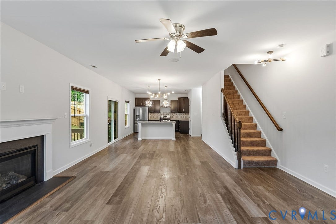 2007 Arcadia Avenue, Chester, VA 23831 Expansive living area featuring wood-finish flooring, a white mantel fireplace, and a ceiling fan
