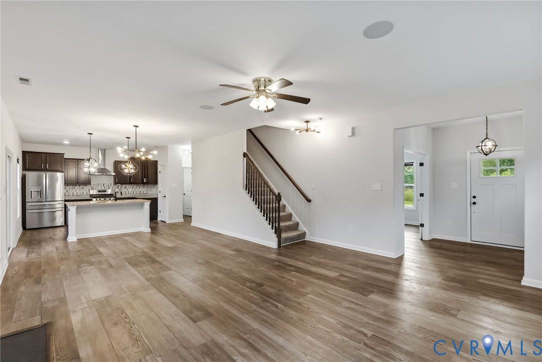 2007 Arcadia Avenue, Chester, VA 23831 Open-concept living area featuring wood-finish flooring, a contemporary kitchen with stainless steel appliances, a central island, and dark wood cabinetry