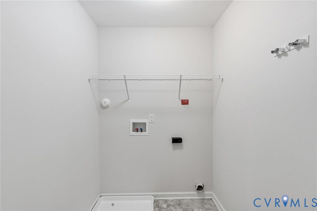 2007 Arcadia Avenue, Chester, VA 23831 Dedicated laundry area with durable flooring, essential hookups, and integrated wire shelving