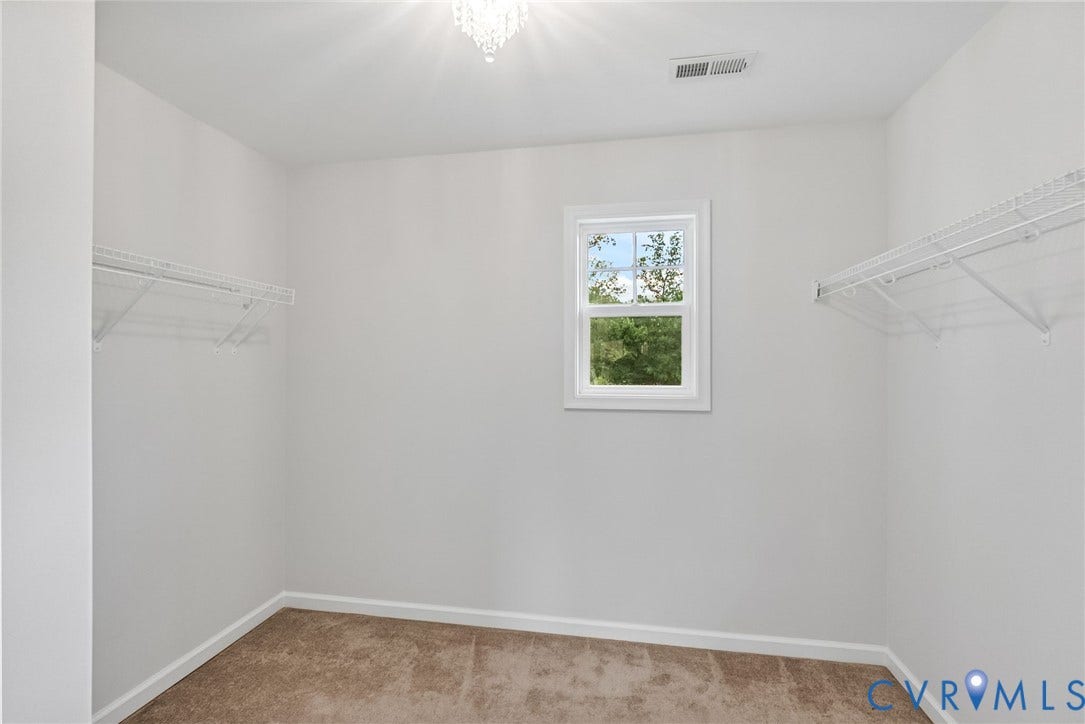 2007 Arcadia Avenue, Chester, VA 23831 Walk-in closet featuring plush carpeting, white wire shelving, a double-paned window, and a decorative ceiling light fixture