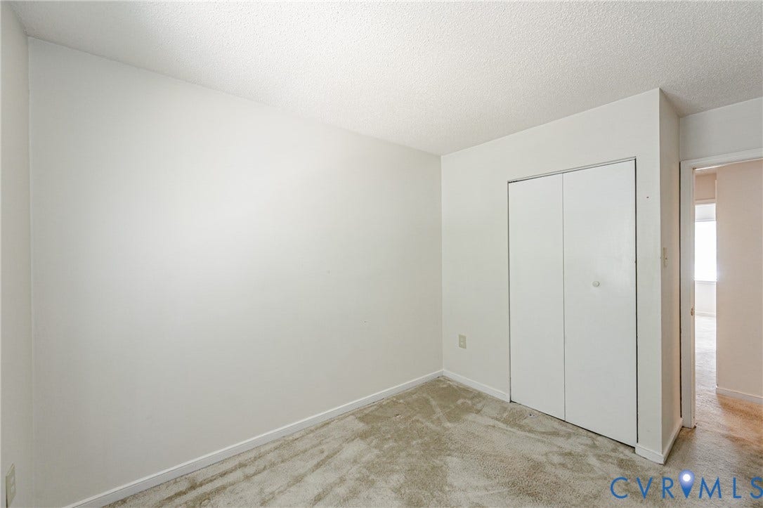Neutral-toned walls and carpeted flooring define this interior space