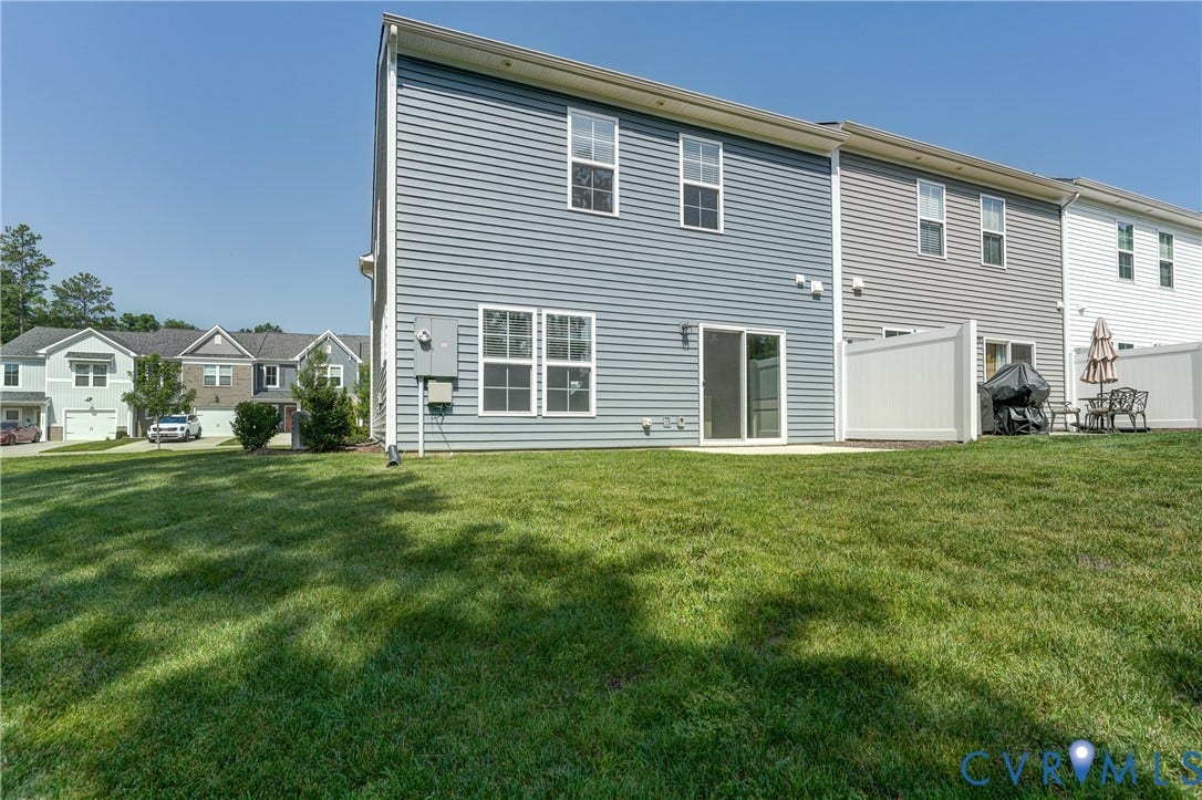 Expansive green lawn with a private patio area