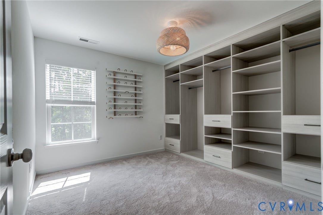Integrated custom closet system featuring shelving and drawer storage