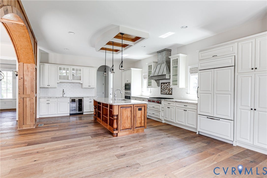 1978 Farnborough Drive, Midlothian, VA 23112 Gourmet kitchen featuring a wood-finish island with seating, white shaker cabinetry, stainless steel appliances, and a coffered ceiling detail with recessed lighting