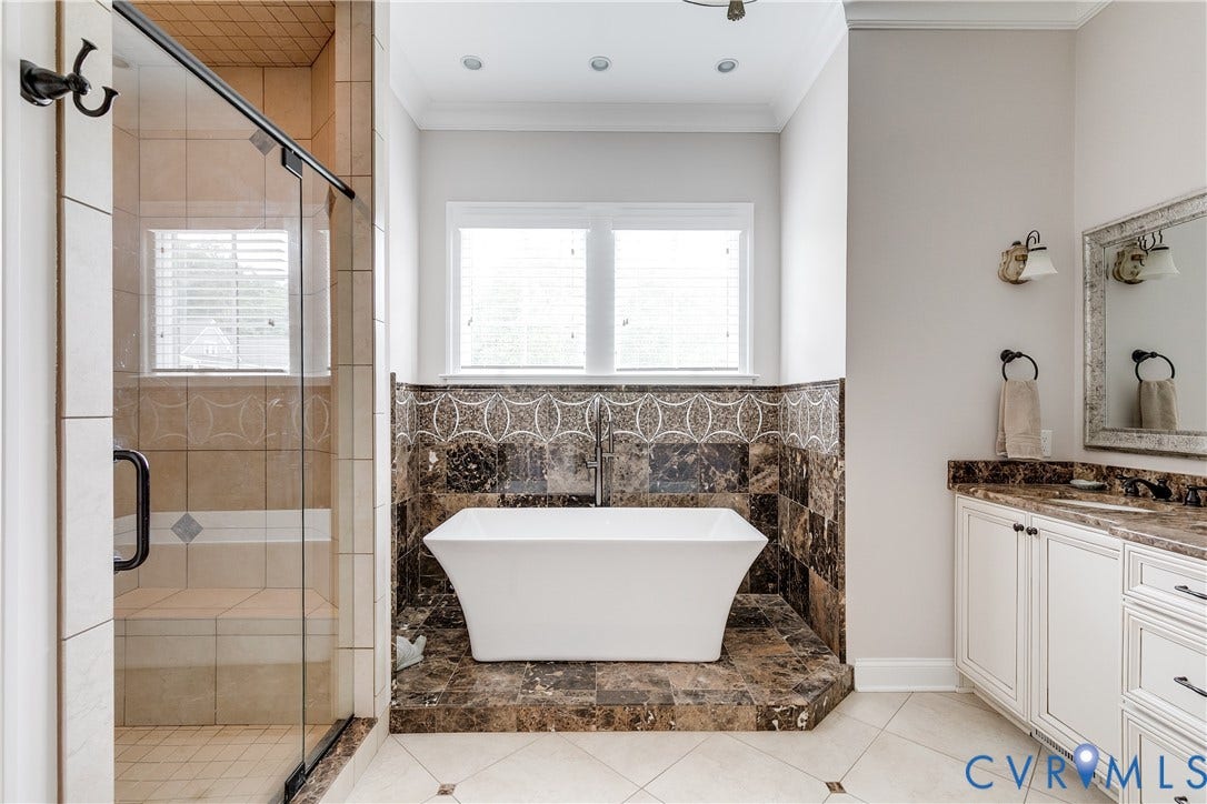 1978 Farnborough Drive, Midlothian, VA 23112 Freestanding soaking tub with dark tile surround and mosaic detail