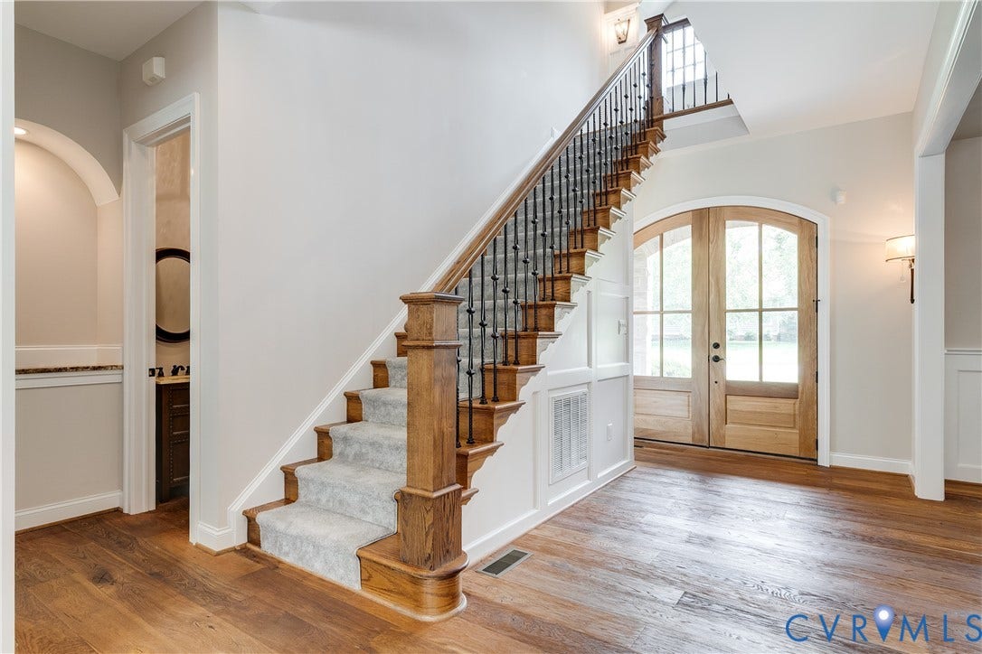 1978 Farnborough Drive, Midlothian, VA 23112 Grand entryway featuring wood-finish flooring and a staircase with wood newel posts, balusters, and carpeted treads