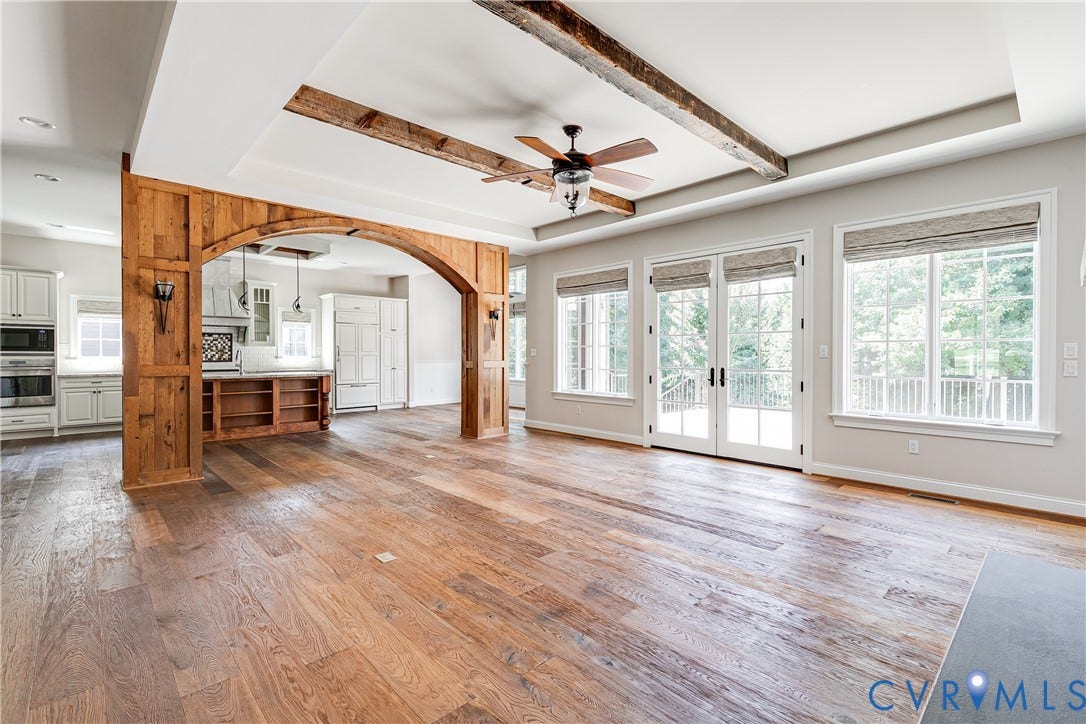 1978 Farnborough Drive, Midlothian, VA 23112 Living area featuring wood-finish flooring and a wood-paneled archway leading to the kitchen