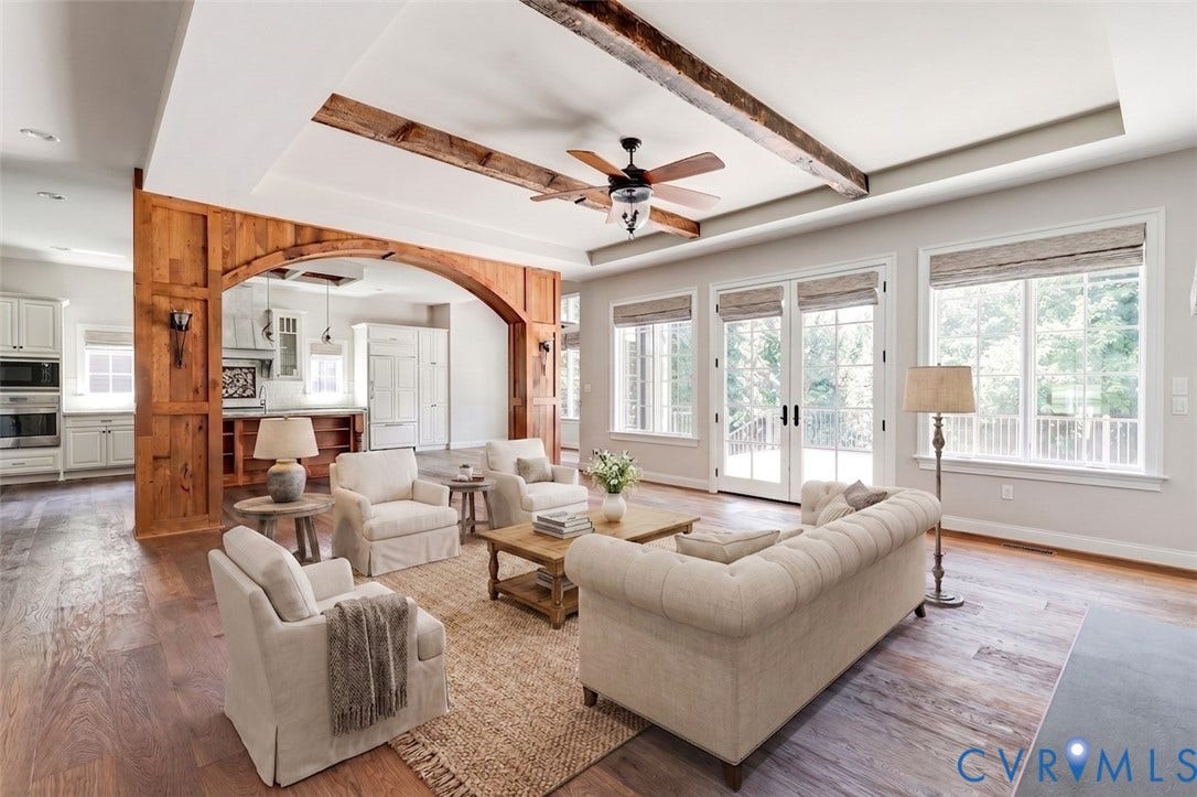 1978 Farnborough Drive, Midlothian, VA 23112 Expansive living area featuring wide plank wood-finish flooring, a tray ceiling with exposed wood beams, and a ceiling fan. Virtually Staged