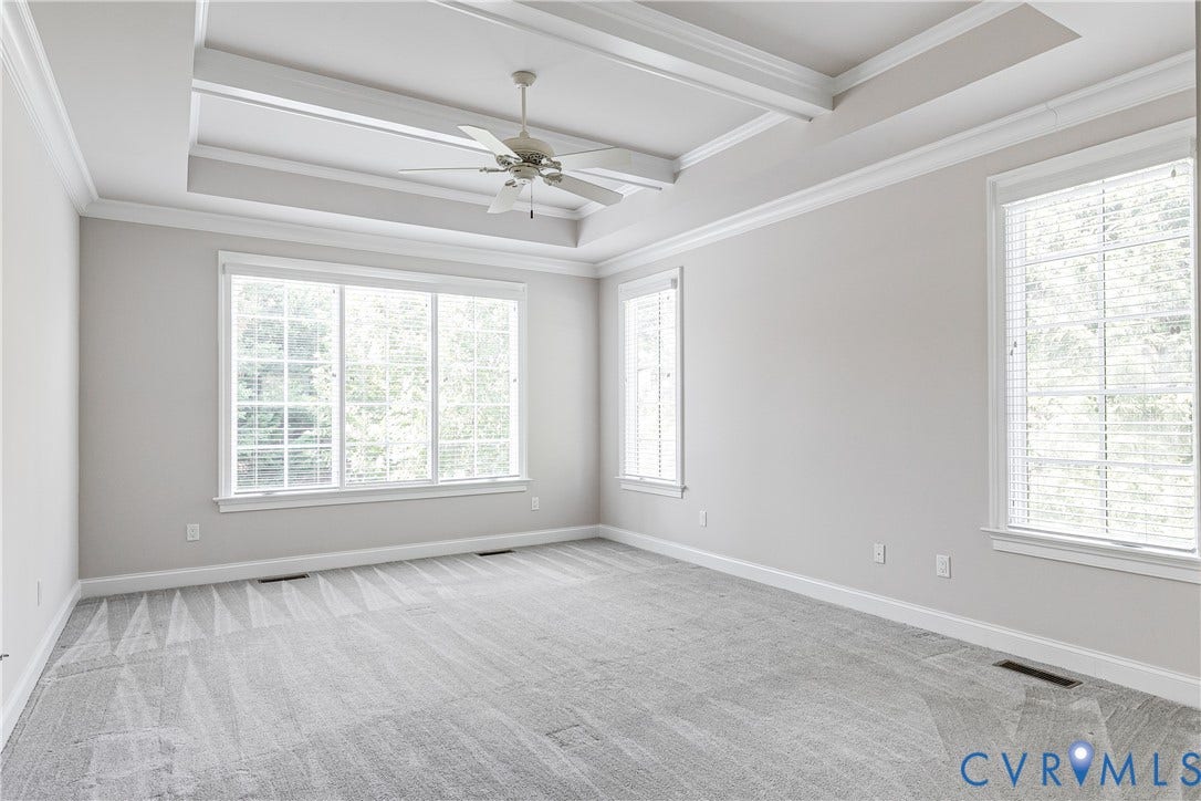 1978 Farnborough Drive, Midlothian, VA 23112 Bright room featuring expansive windows with white blinds, tray ceiling, and light gray wall paint.