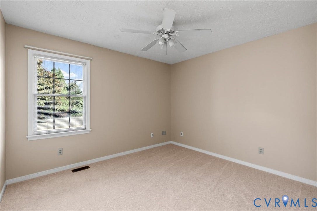 1437 Palmore Road, Powhatan, VA 23139 Neutral-toned walls complement plush carpeting