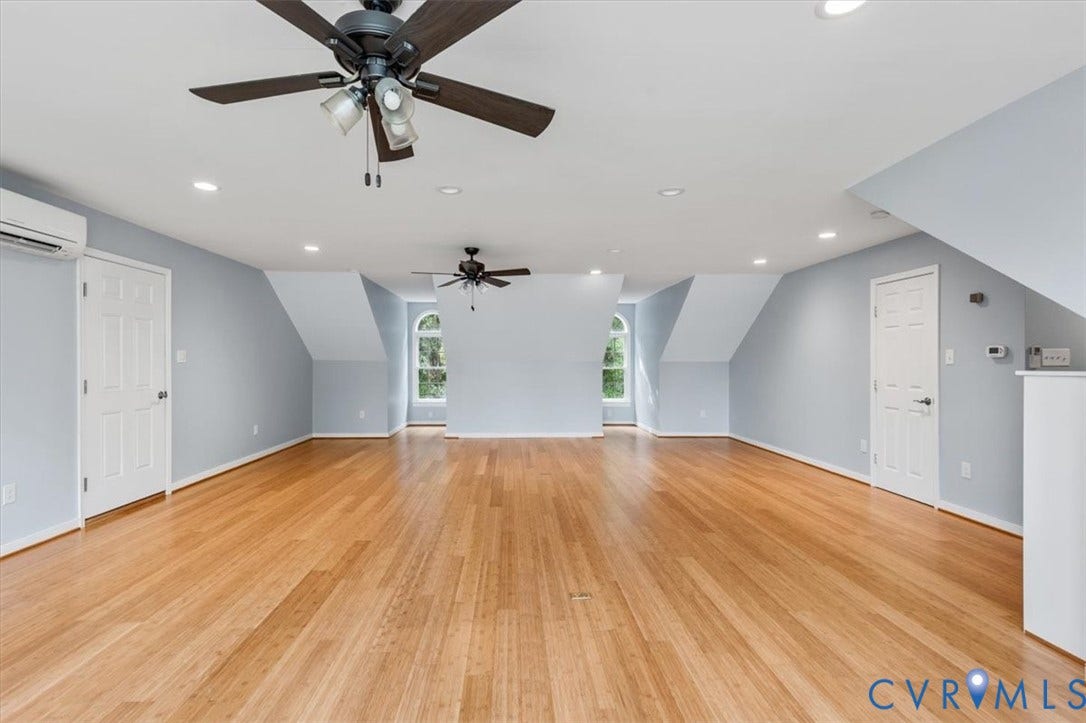 1437 Palmore Road, Powhatan, VA 23139 Expansive room featuring wood-finish flooring, two arched windows, recessed lighting, and multiple ceiling fans