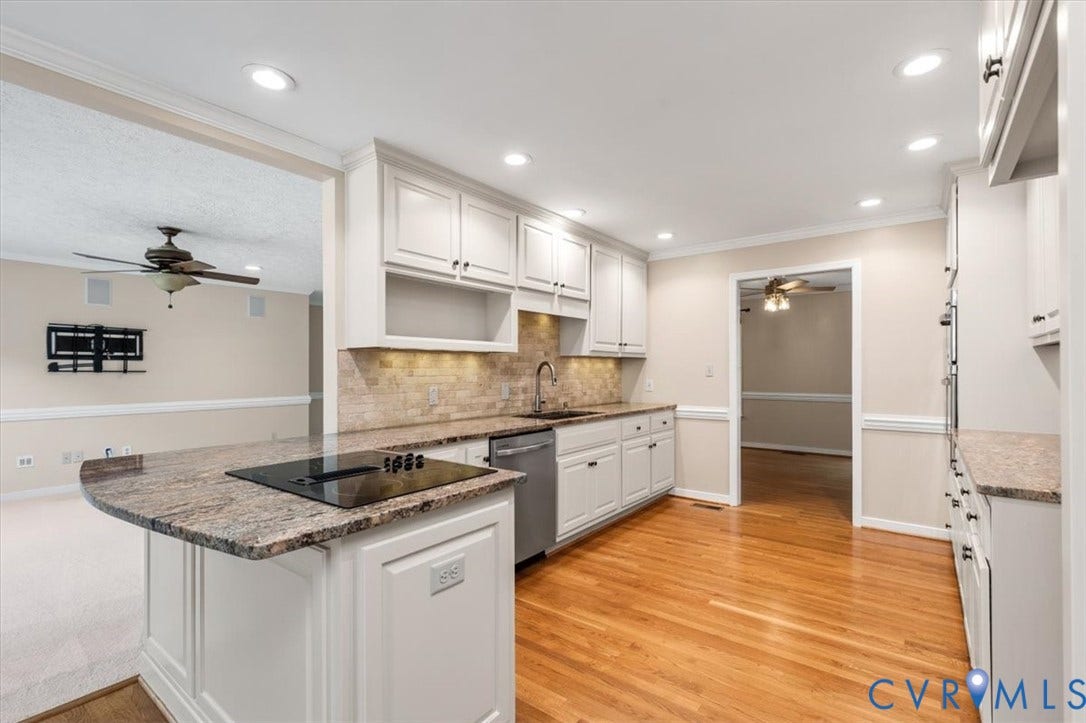 1437 Palmore Road, Powhatan, VA 23139 Kitchen featuring light wood-finish flooring, white cabinetry, integrated stainless steel dishwasher, and a granite-finish countertop with a built-in cooktop