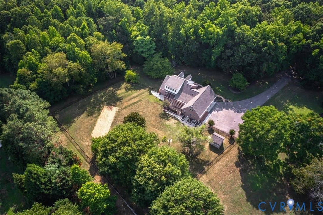 1437 Palmore Road, Powhatan, VA 23139 Brick exterior residence featuring a paved driveway, a large fenced yard, and surrounding mature trees