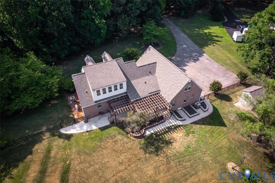 1437 Palmore Road, Powhatan, VA 23139 Brick exterior home with a gabled roof, rear patio with a pergola, and a large paved driveway