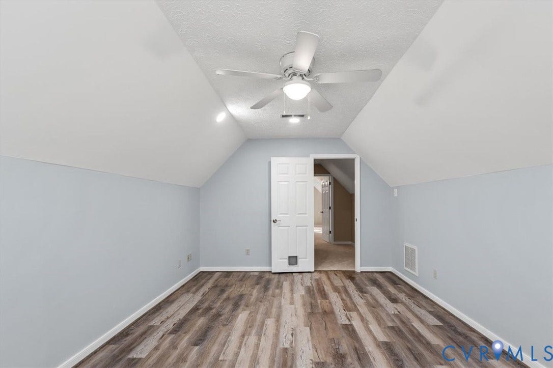 1437 Palmore Road, Powhatan, VA 23139 Room featuring sloped ceilings, wood-finish flooring, and light blue walls