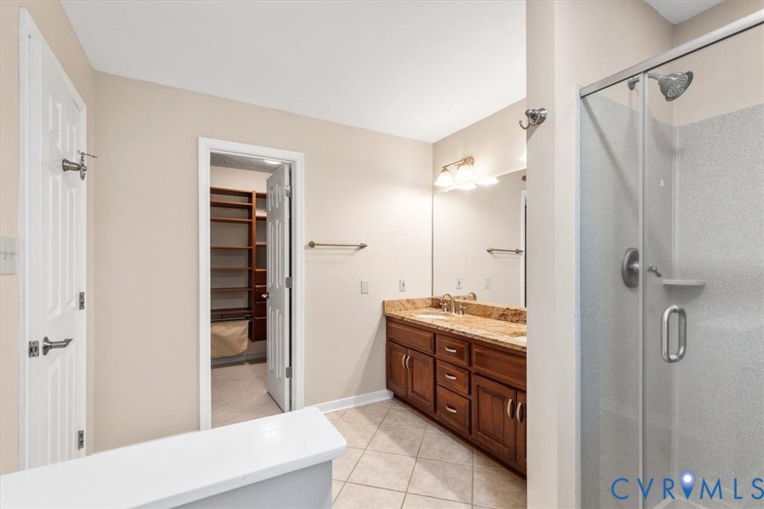 1437 Palmore Road, Powhatan, VA 23139 Bathroom featuring a dual vanity with a stone countertop, an integrated sink, and a glass-enclosed shower