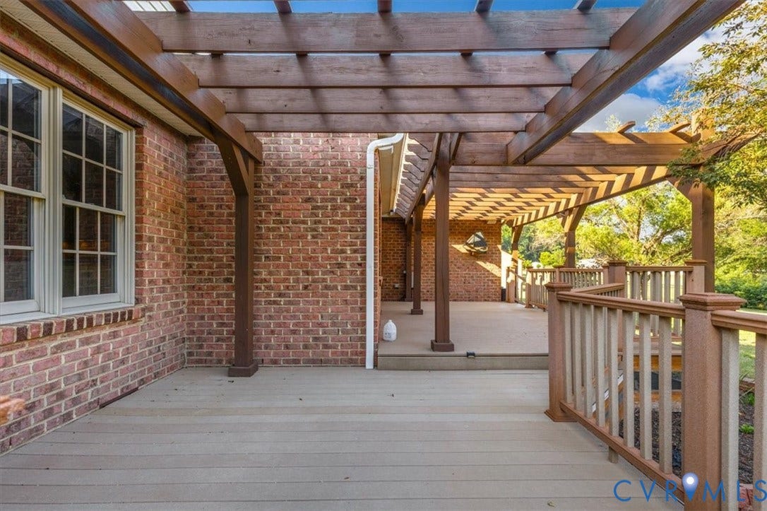 1437 Palmore Road, Powhatan, VA 23139 Expansive outdoor deck featuring composite decking, a pergola, and a brick exterior