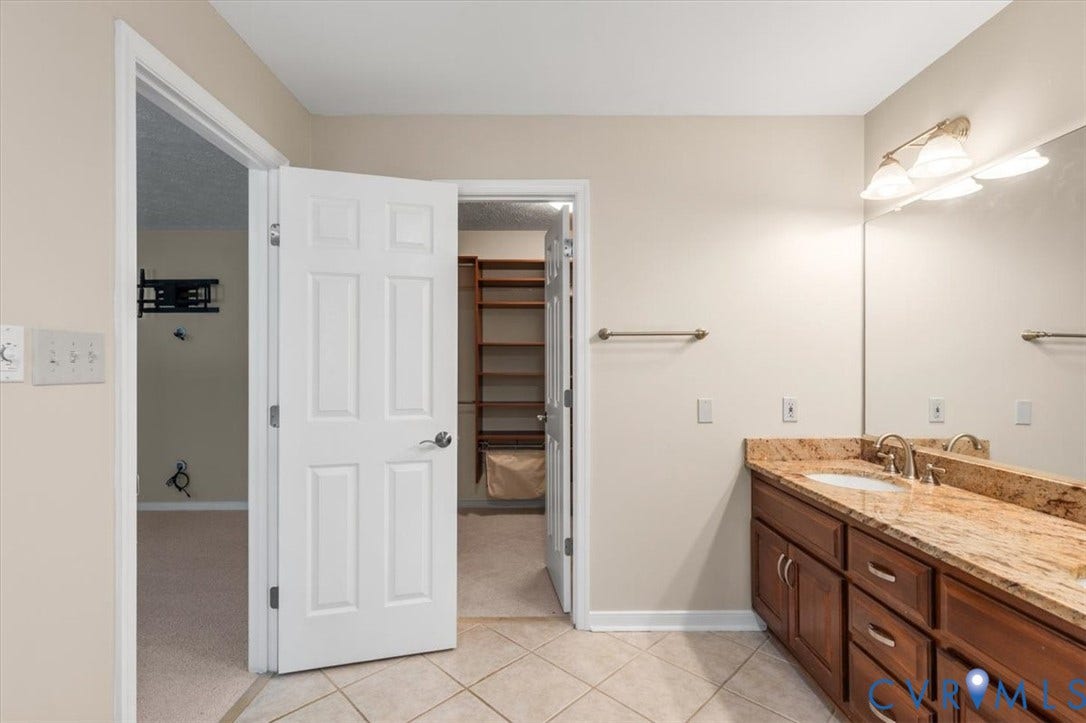 1437 Palmore Road, Powhatan, VA 23139 Bathroom featuring a double vanity with stone countertop, dual undermount sinks, and tile flooring