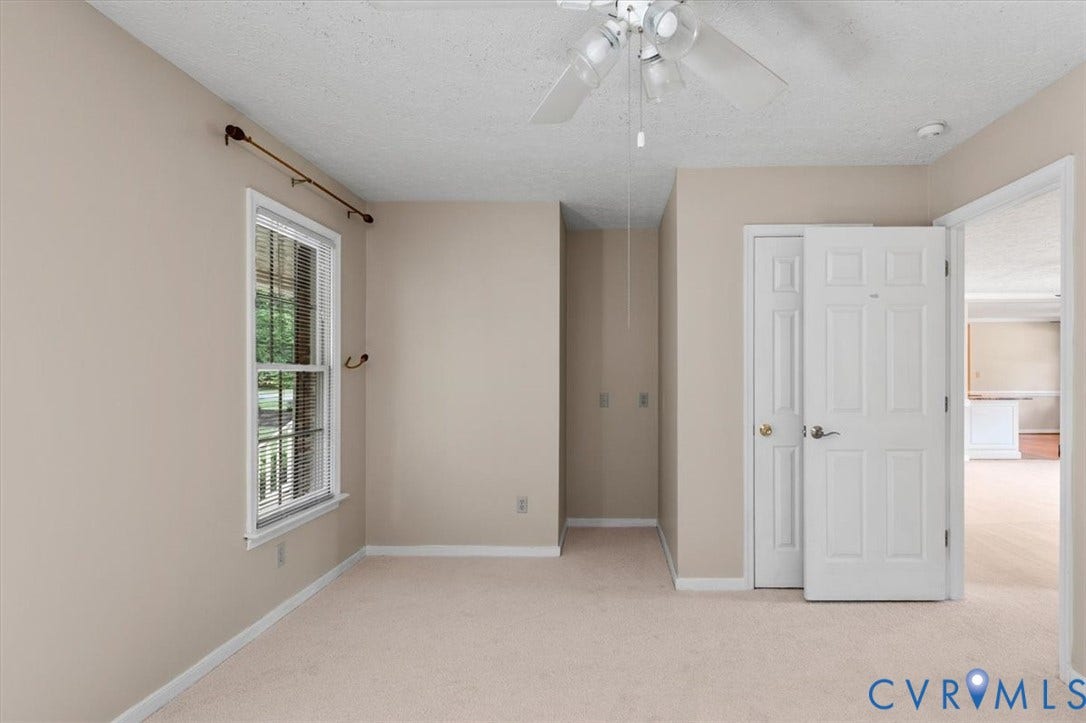 1437 Palmore Road, Powhatan, VA 23139 Neutral-toned room featuring a single window with blinds, light beige carpeting, and a white ceiling fan