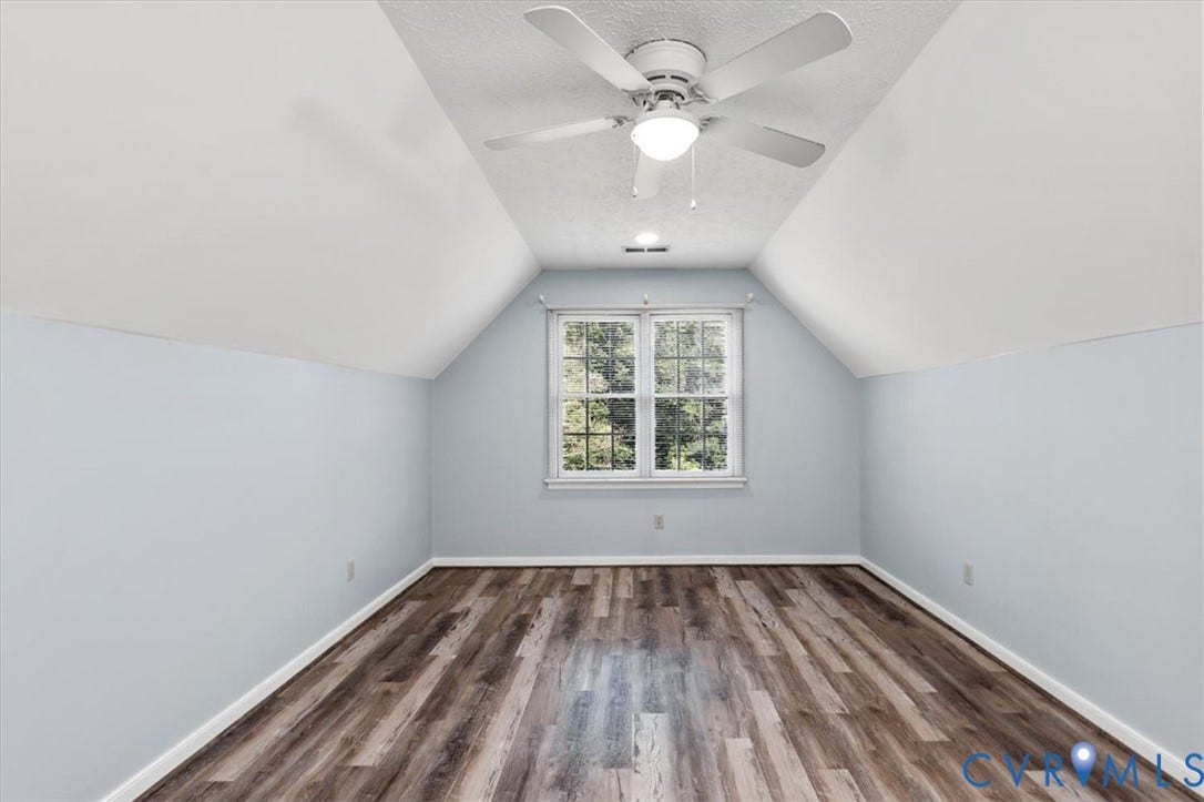 1437 Palmore Road, Powhatan, VA 23139 Spacious room featuring wood-finish flooring, a ceiling fan with integrated lighting, a recessed light fixture, and a large window providing outdoor scenery